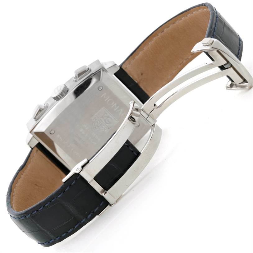 The image shows the back case and partially opened clasp of a Monaco model watch by Tag Heuer.
