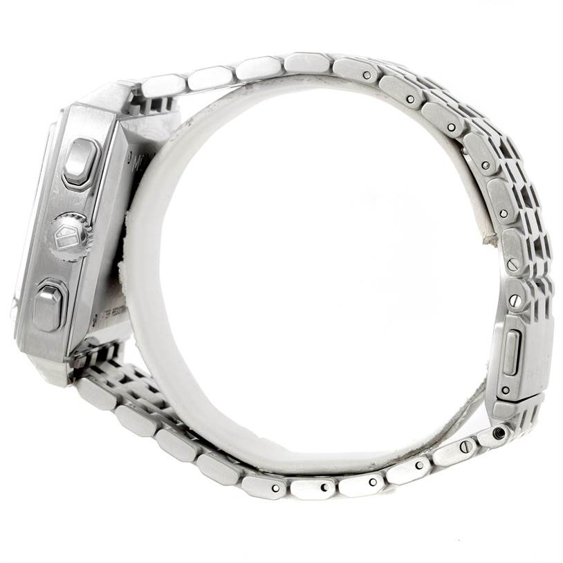 This side view of a Tag Heuer Monaco CW2113 Men's Stainless Steel Blue Dial CW2113 Men's Stainless Steel Blue Dial watch shows the case, crown, pushers, and the metal bracelet.