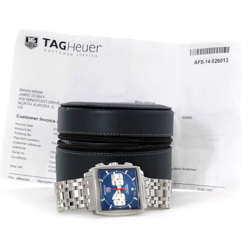 The Tag Heuer Monaco CW2113 Men's Stainless Steel Blue Dial CW2113 Men's Stainless Steel Blue Dial watch is shown from the front with its case and documents in the background.