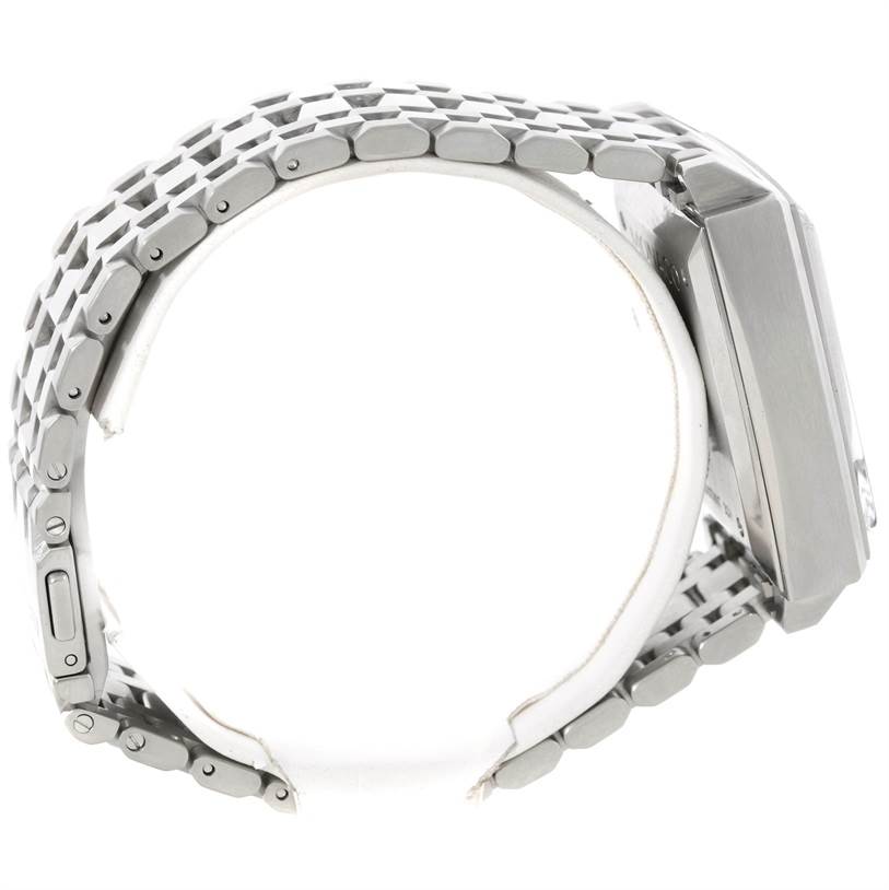 The image shows a side view of a Tag Heuer Monaco CW2113 Men's Stainless Steel Blue Dial CW2113 Men's Stainless Steel Blue Dial watch, highlighting its metal bracelet and rectangular case.