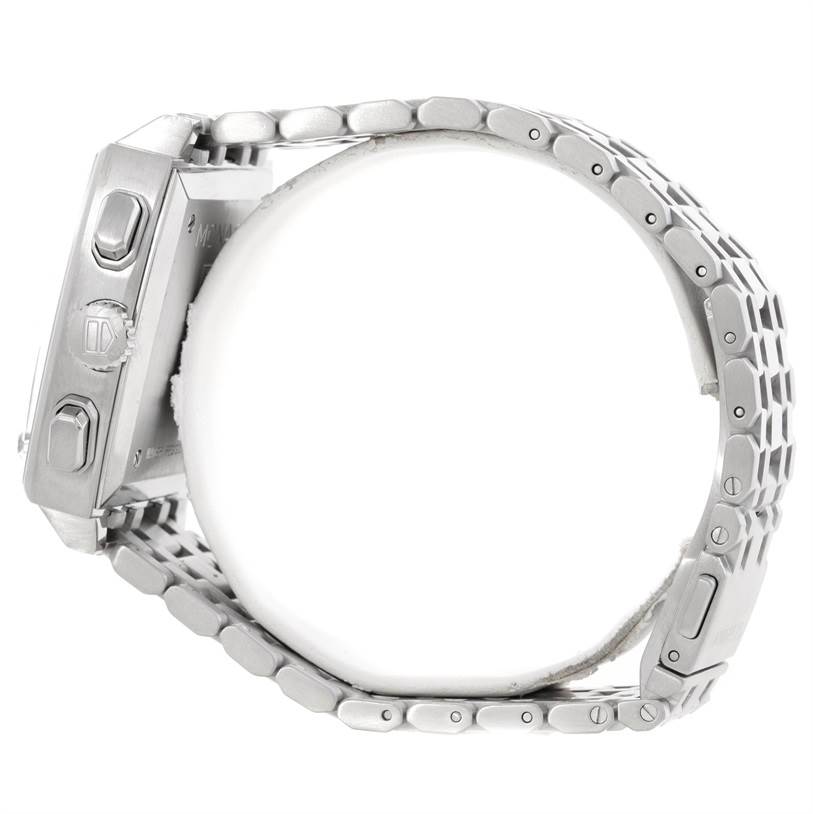 The image shows a side view of a Tag Heuer Monaco CW2113 Men's Stainless Steel Blue Dial CW2113 Men's Stainless Steel Blue Dial watch, focusing on the case buttons and metal bracelet.