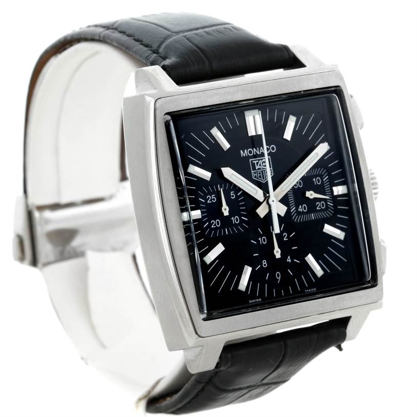 The image shows a Tag Heuer Monaco CW2111 Men
s Stainless Steel Black Dial CW2111 Men
s Stainless Steel Black Dial watch at a slight angle, highlighting its square dial, black leather strap, and chronograph subdials.