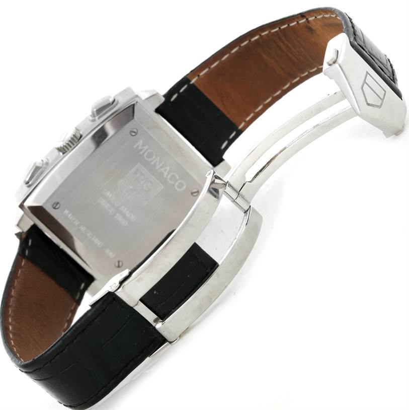 The image shows the back view of a Tag Heuer Monaco CW2111 Men
s Stainless Steel Black Dial CW2111 Men
s Stainless Steel Black Dial watch, highlighting the case back and part of the black leather strap with the clasp.