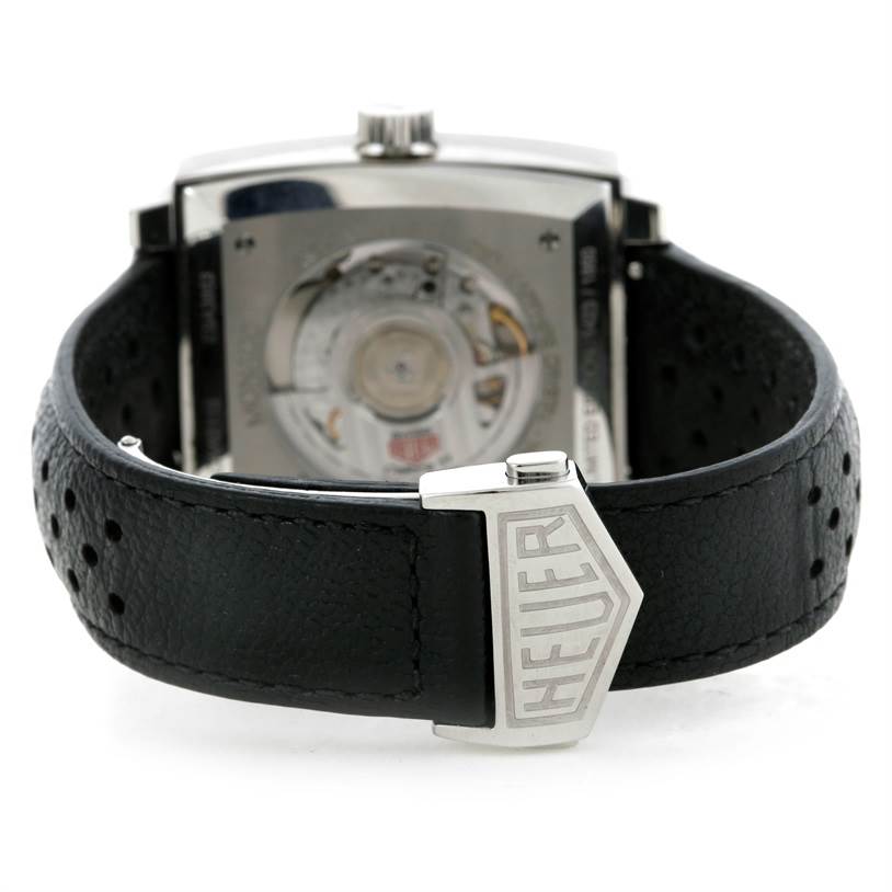 The image shows the back view of a Limited Edition Tag Heuer watch and its leather strap with "Heuer" engraved on the clasp.