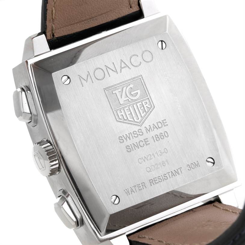 The image shows the back case of the Tag Heuer Monaco CW2113 Men
s Stainless Steel Blue Dial CW2113 Men
s Stainless Steel Blue Dial watch, showcasing its engravings and side buttons.