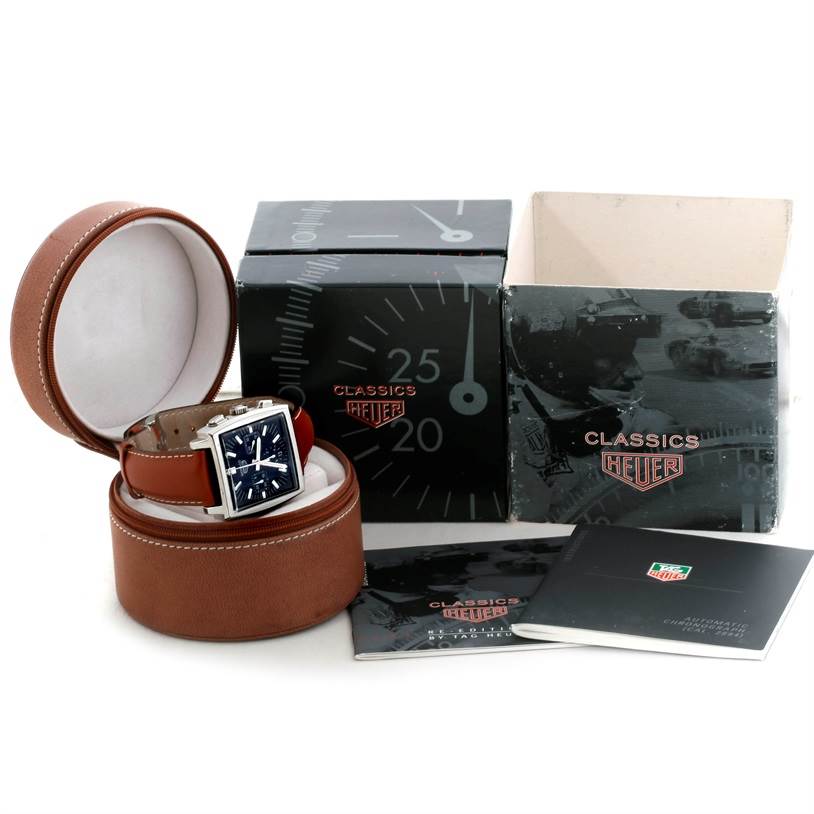 The image shows a Tag Heuer Monaco CS2111 Men's Stainless Steel Black Dial CS2111 Men's Stainless Steel Black Dial watch in its case, along with its packaging and manuals, photographed from a front angle.