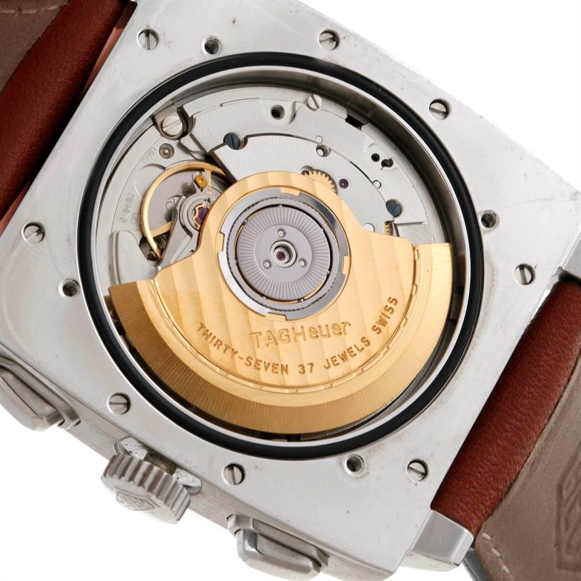 The image shows the back view of the Tag Heuer Monaco CS2111 Men's Stainless Steel Black Dial CS2111 Men's Stainless Steel Black Dial watch, highlighting its mechanical movement and rotor.