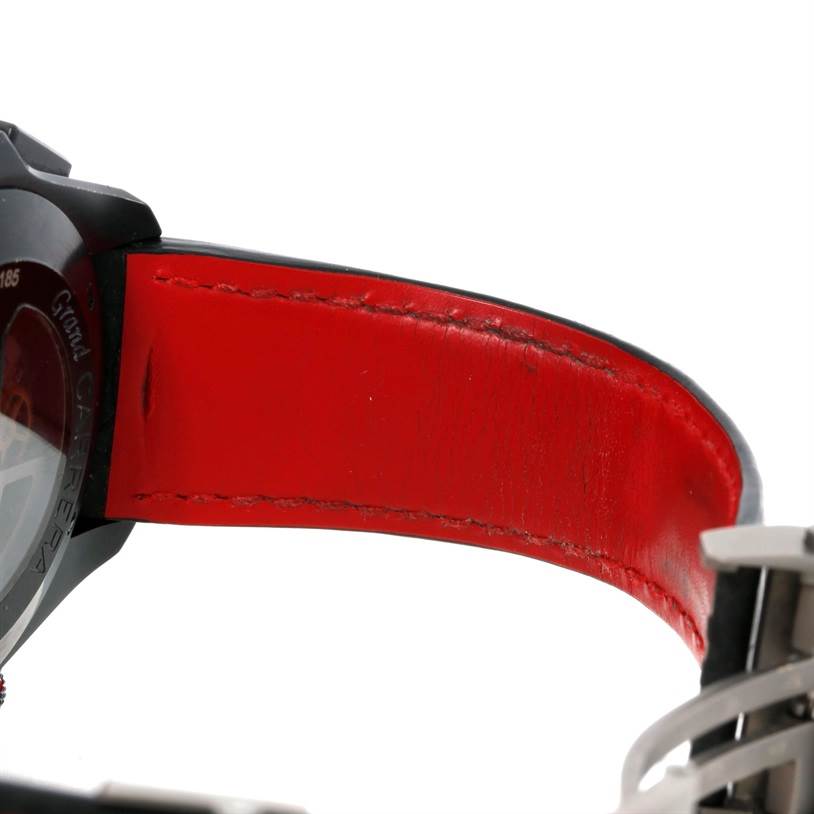This is a close-up of the case back and red leather strap of a Tag Heuer Carrera CAV5185.FC6237 Men's Titanium Black Dial CAV5185.FC6237 Men's Titanium Black Dial watch.