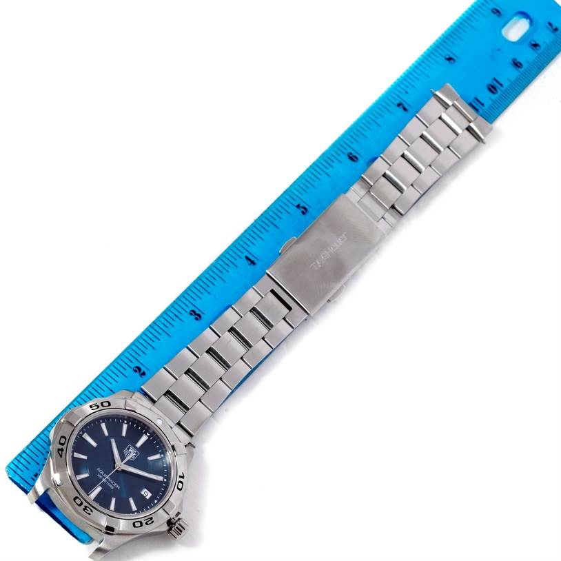 The image shows a Tag Heuer Aquaracer WAP1112 Men's Stainless Steel Blue Dial WAP1112 Men's Stainless Steel Blue Dial watch with a blue ruler, highlighting the watch case, face, and full metal bracelet.