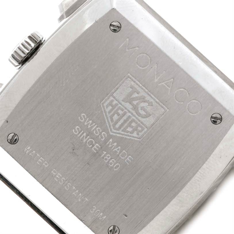 The image shows the back case of a Tag Heuer Monaco CW2114 Men's Stainless Steel Brown Dial CW2114 Men's Stainless Steel Brown Dial watch, highlighting its engravings and water resistance.