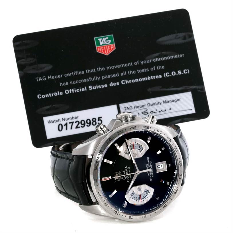 The image shows a front view of a Tag Heuer Carrera CAV511A.FC6225 Men's Stainless Steel Black Dial CAV511A.FC6225 Men's Stainless Steel Black Dial watch with its certification card in the background.