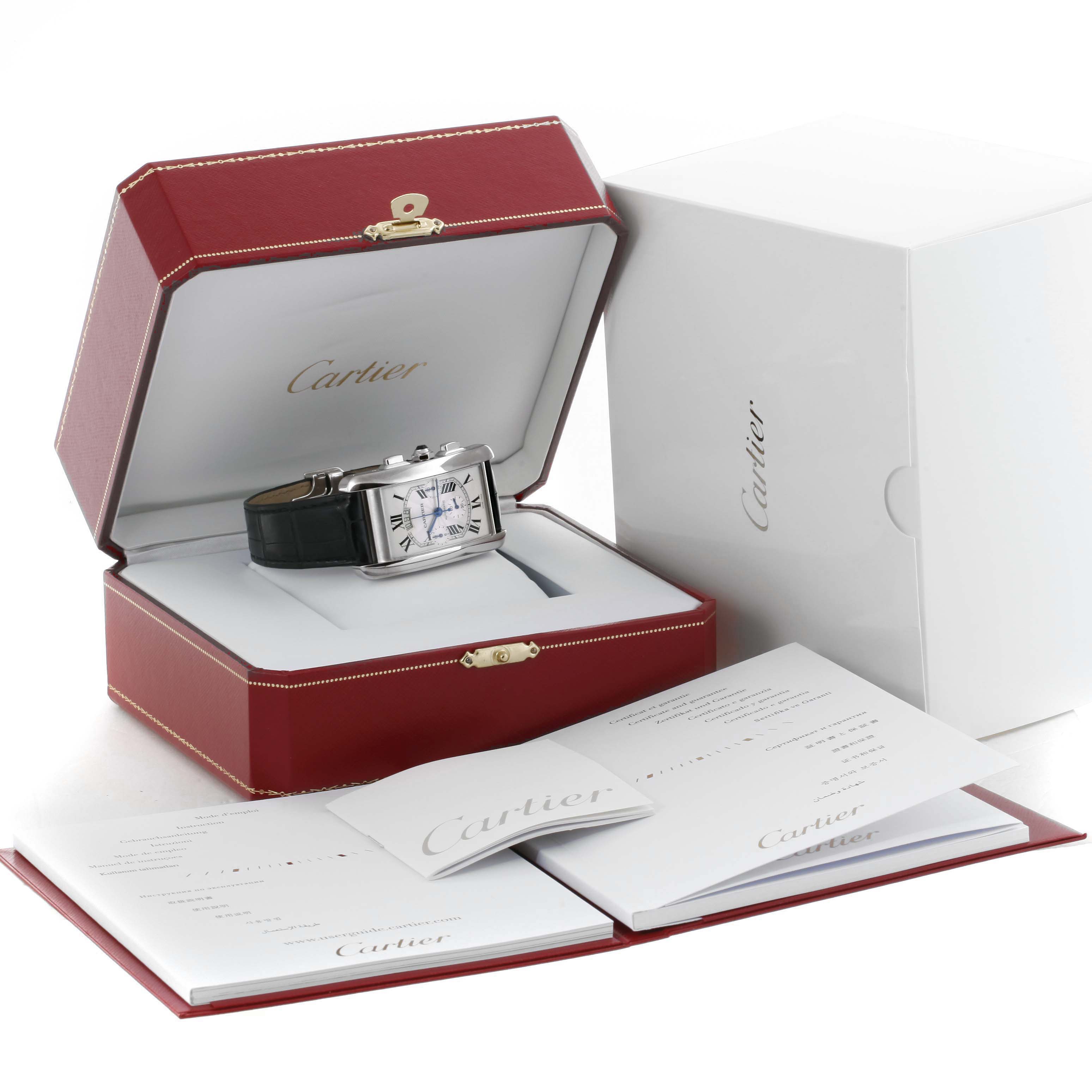 The Cartier Tank Américaine watch and its accessories are displayed from a front angle, showing its box, manuals, and packaging.