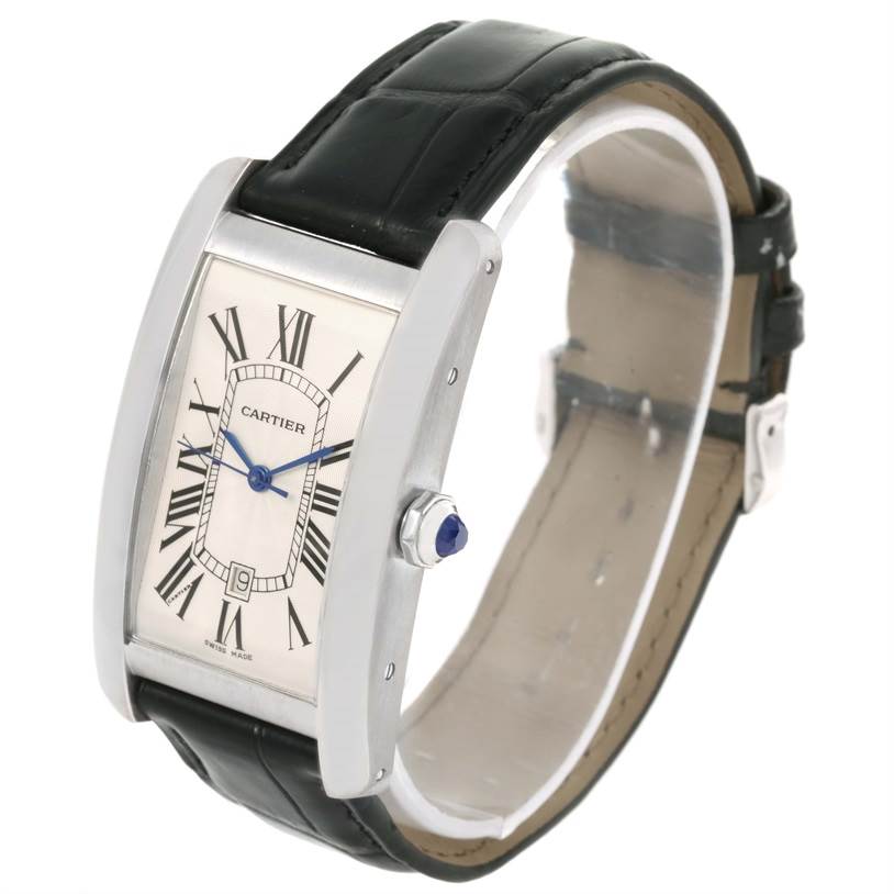 The image shows a Cartier Tank Americaine W2603256 Men's White Gold Silver Dial W2603256 Men's White Gold Silver Dial watch at a three-quarter angle, highlighting its face, crown, and leather strap.