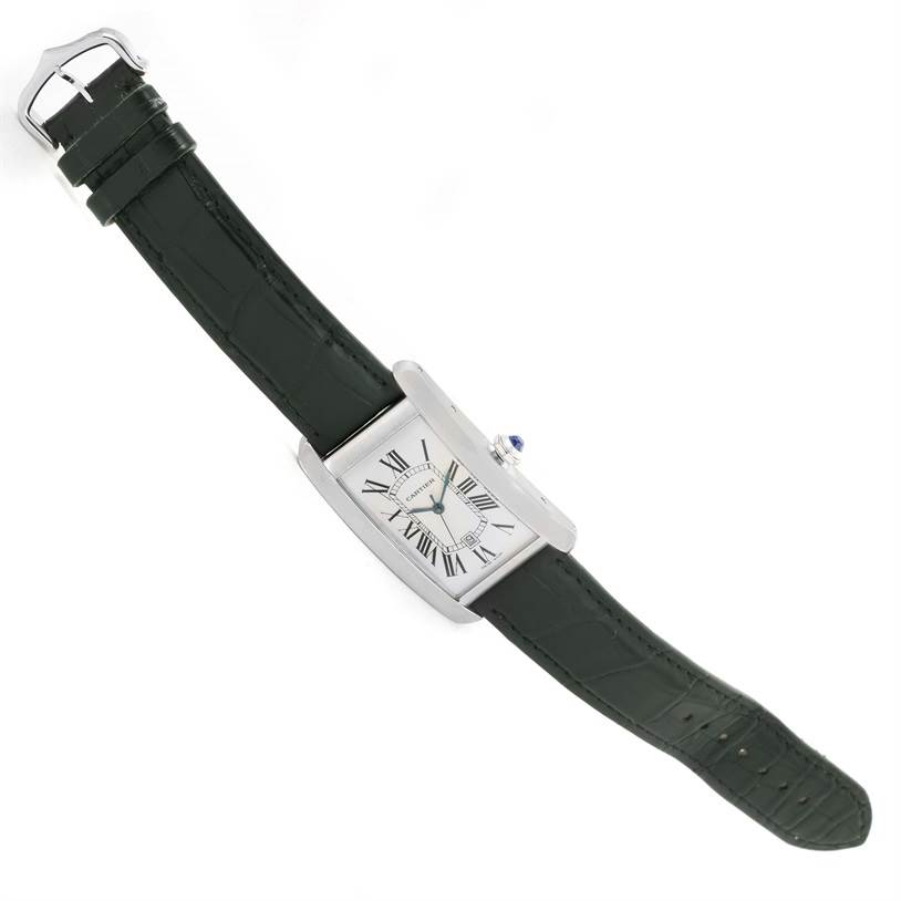 The image shows a Cartier Tank Americaine W2603256 Men's White Gold Silver Dial W2603256 Men's White Gold Silver Dial watch from a top-down angle, highlighting its rectangular face and black leather strap.