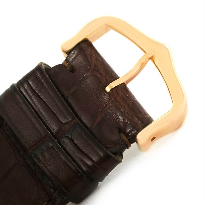 The image shows a close-up of a brown leather watch strap and gold buckle of a Cartier Tank Americaine W2609156 Rose Gold Silver Dial W2609156 Rose Gold Silver Dial model.