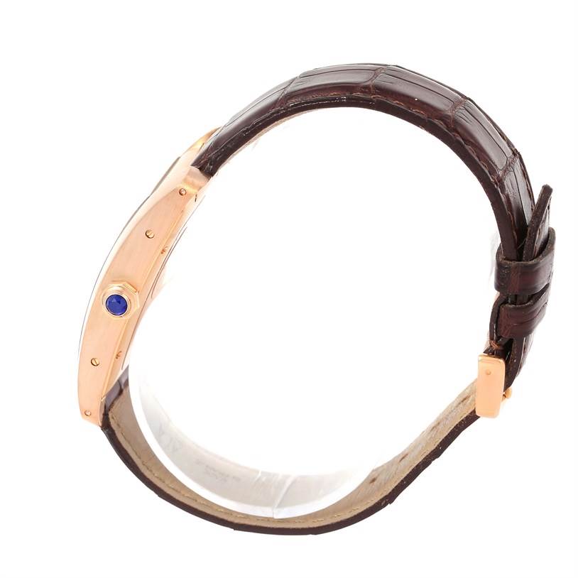 The Cartier Tank Americaine W2609156 Rose Gold Silver Dial W2609156 Rose Gold Silver Dial watch is shown from a side angle, highlighting the case, crown, and leather strap.