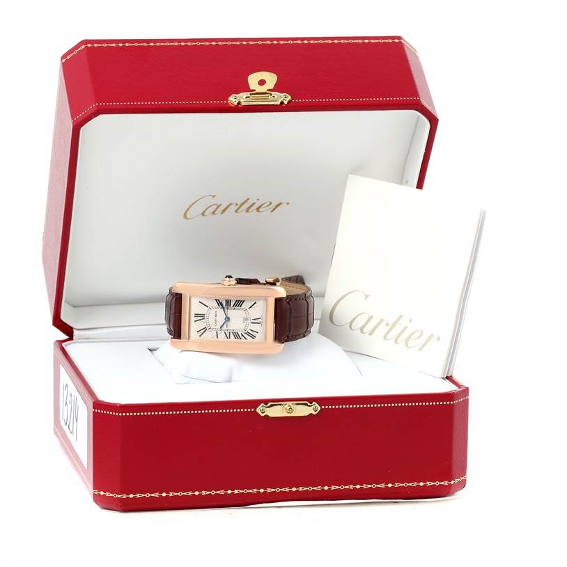 The Cartier Tank Americaine W2609156 Rose Gold Silver Dial W2609156 Rose Gold Silver Dial watch is shown from the front angle inside its red box, along with its booklet.