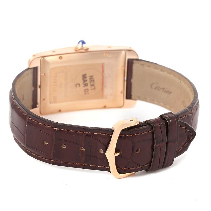 The image shows the back and the brown leather strap with a gold buckle of a Cartier Tank Americaine W2609156 Rose Gold Silver Dial W2609156 Rose Gold Silver Dial watch.