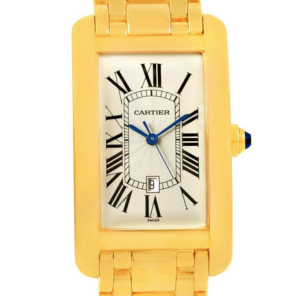 The image shows a frontal view of the Cartier Tank Americaine W26031K2 Men
s Yellow Gold Silver Dial W26031K2 Men
s Yellow Gold Silver Dial watch, highlighting its rectangular gold case, Roman numeral dial, and blue hands.