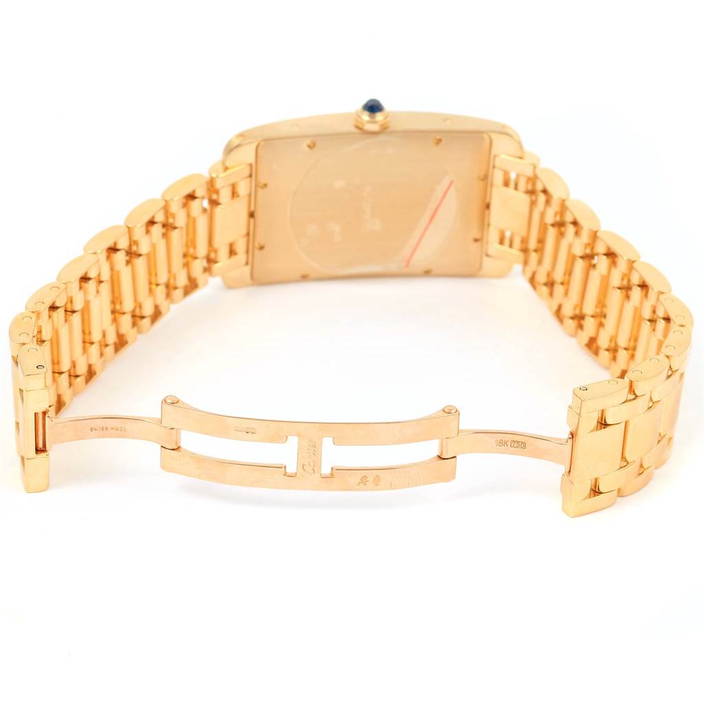 This image shows the back and clasp of a Cartier Tank Americaine W26031K2 Men
s Yellow Gold Silver Dial W26031K2 Men
s Yellow Gold Silver Dial watch, highlighting its gold bracelet.