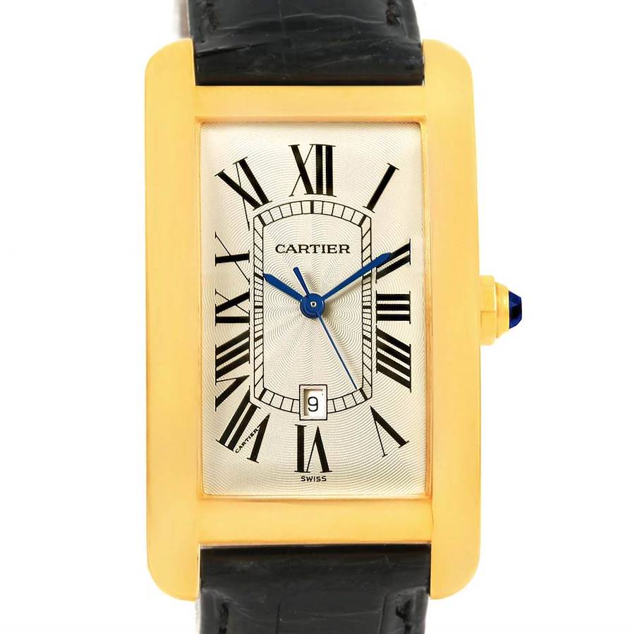 The image shows a front view of the Cartier Tank Americaine watch, highlighting the rectangular gold case, black Roman numerals, and a black leather strap.