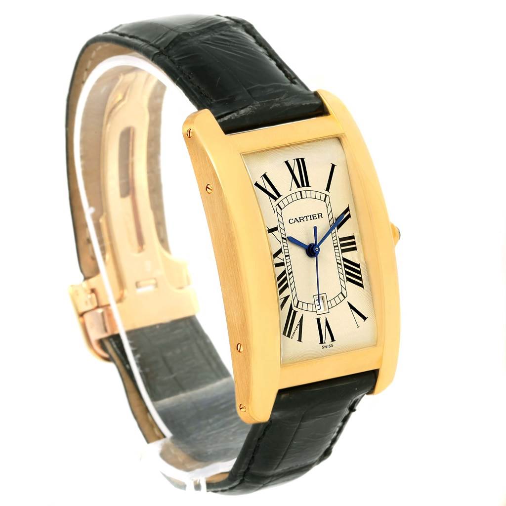 The Cartier Tank Americaine W2603156 Men's Yellow Gold Silver Dial W2603156 Men's Yellow Gold Silver Dial watch is shown at a front-left angle, displaying its rectangular dial, Roman numerals, and black leather strap.