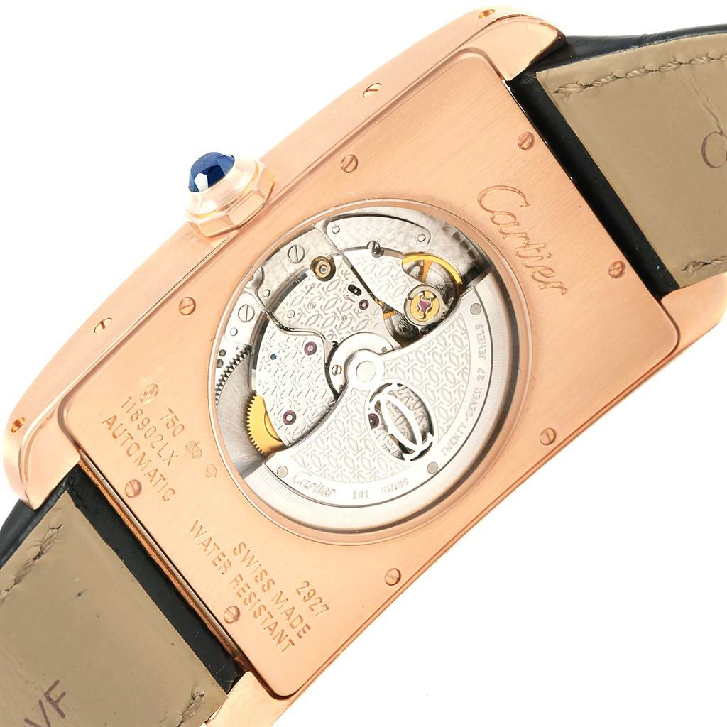 This image shows the back view of the Cartier Tank Americaine W2609856 Men's Rose Gold Silver Dial W2609856 Men's Rose Gold Silver Dial watch, highlighting its automatic movement and inscriptions.