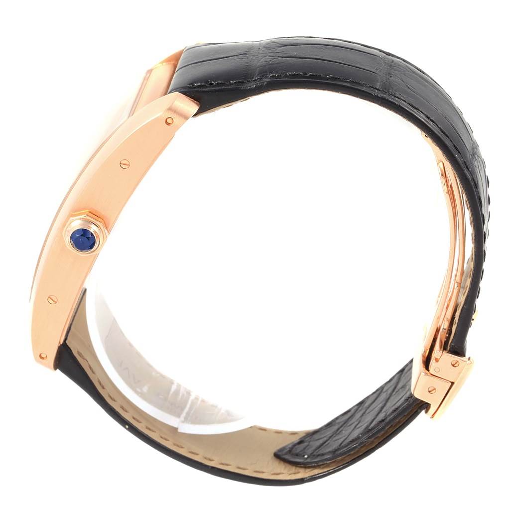 The image shows a side view of the Cartier Tank Americaine W2609856 Men's Rose Gold Silver Dial W2609856 Men's Rose Gold Silver Dial watch, highlighting its crown with a blue gemstone and black leather strap.