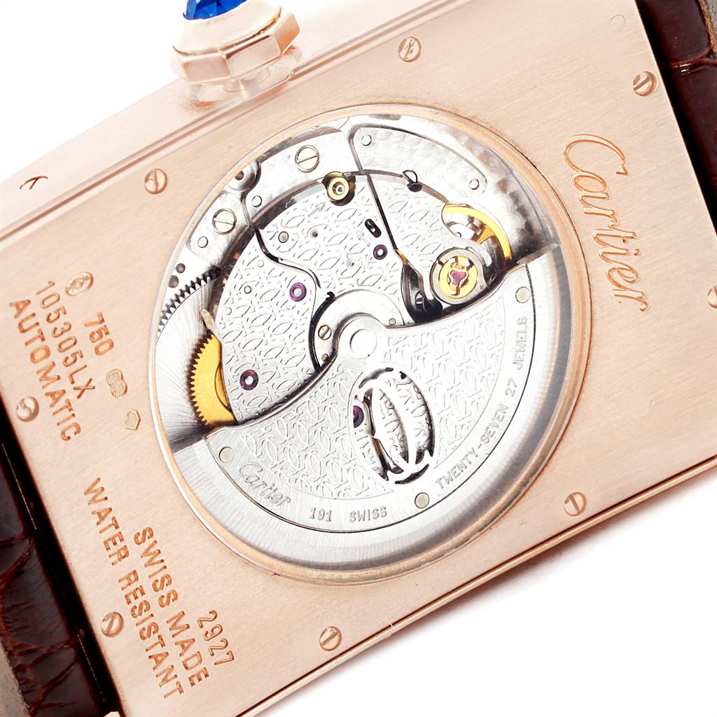 This is the back view of a Cartier Tank Americaine W2609856 Men's Rose Gold Silver Dial W2609856 Men's Rose Gold Silver Dial watch showing its automatic movement and engraved details.