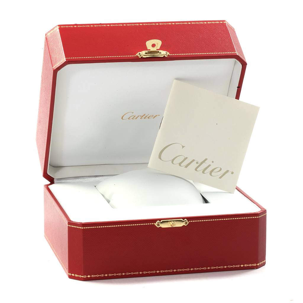 The image shows a closed red Cartier box for a Tank Americaine model watch, along with a Cartier booklet.