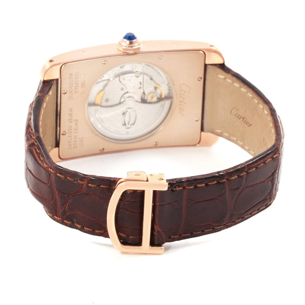 The image shows the backside of the Cartier Tank Americaine W2609856 Men's Rose Gold Silver Dial W2609856 Men's Rose Gold Silver Dial watch, highlighting its mechanical movements and brown leather strap.