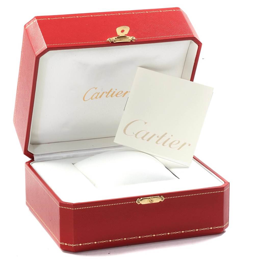 This image shows an open Cartier red watch box for the Tank Américaine model along with related paperwork.