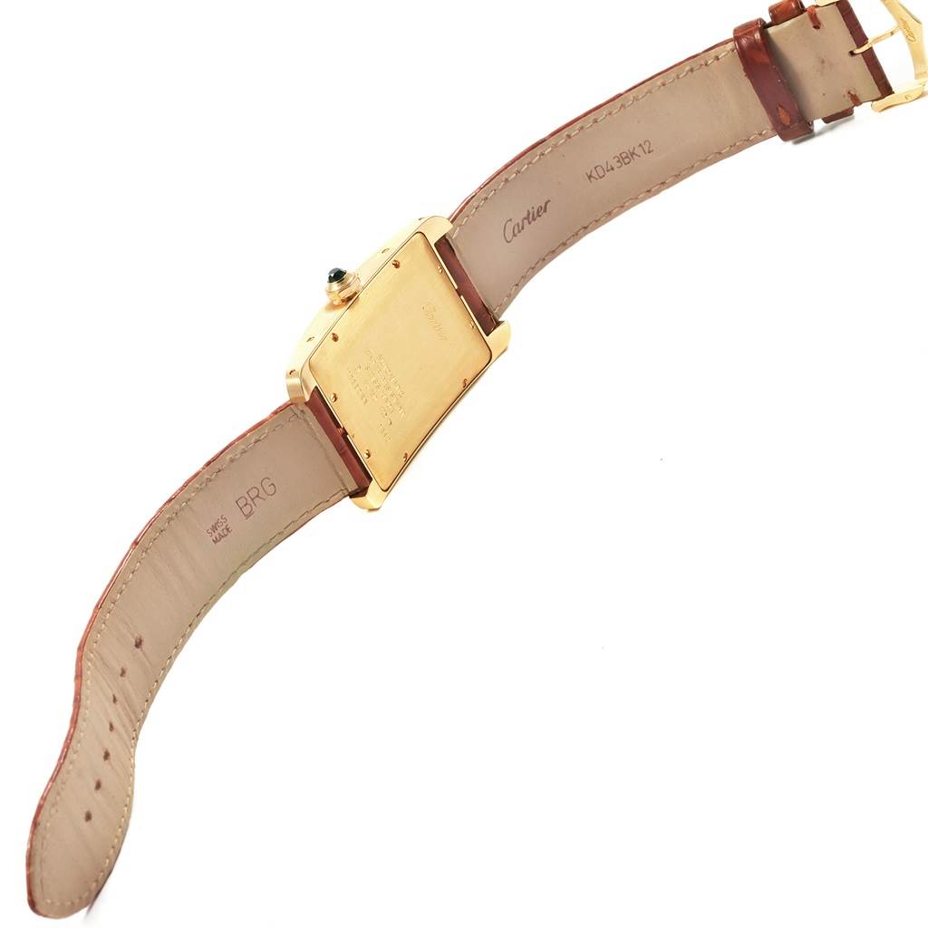 This image shows the backside of a Cartier Tank Américaine watch, including the back cover, strap, and clasp.