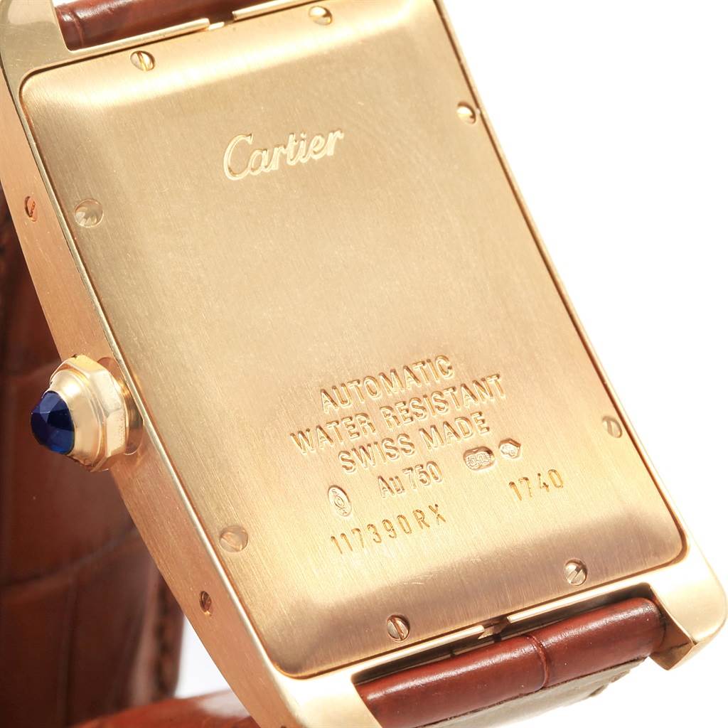 The image shows the back side of the Tank Americaine model by Cartier, highlighting its engravings and crown.