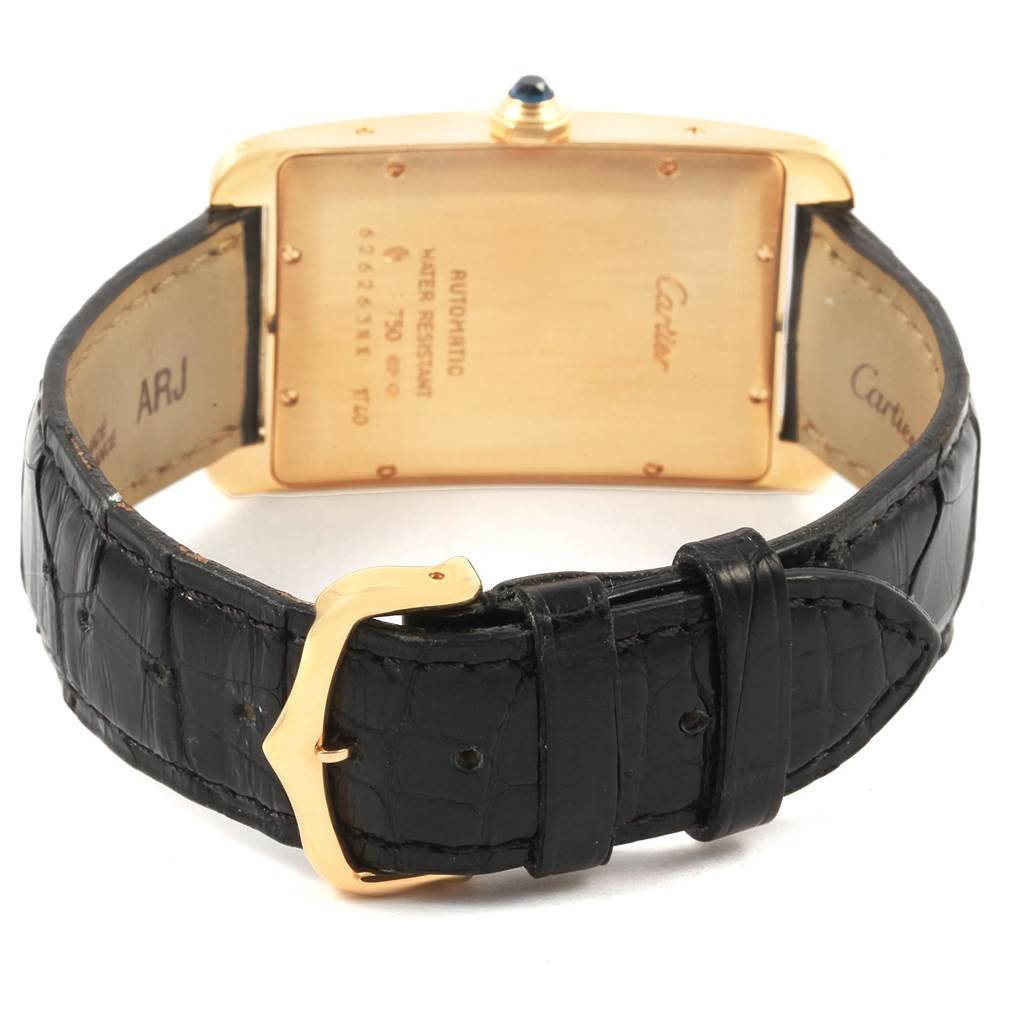 The image shows the back view of a Cartier Tank Americaine W2603156 Men's Yellow Gold Silver Dial W2603156 Men's Yellow Gold Silver Dial watch, featuring its case, strap, and buckle.