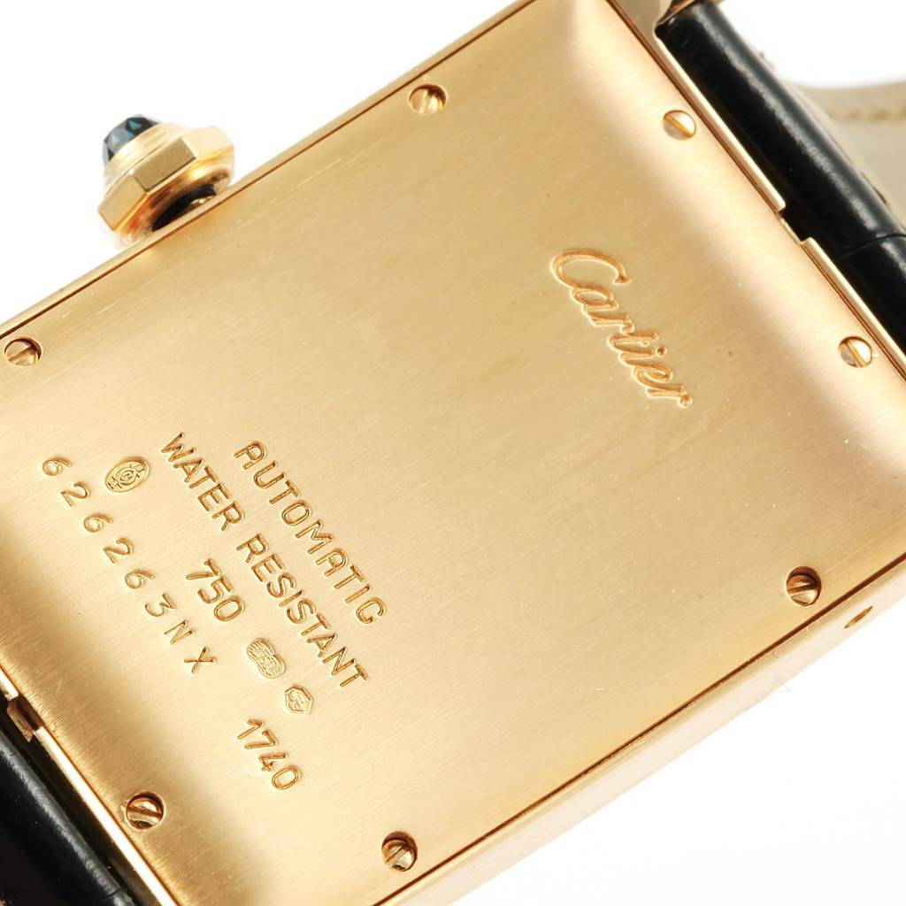This image shows the back case of a Cartier Tank Américaine watch, highlighting the brand name and specifications.