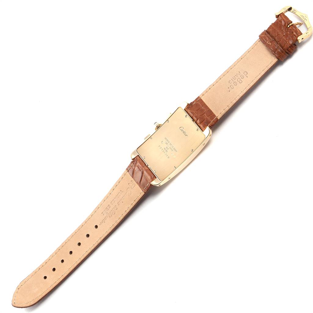 The image shows the back of a Tank Americaine model by Cartier with a brown leather strap.