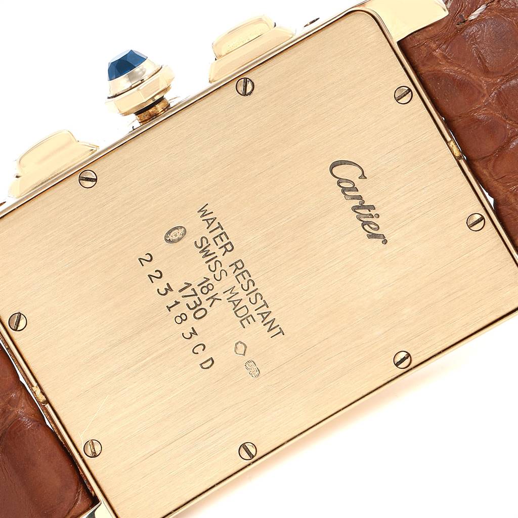 The image shows the back of the Tank Américaine model by Cartier, highlighting its markings and leather strap.