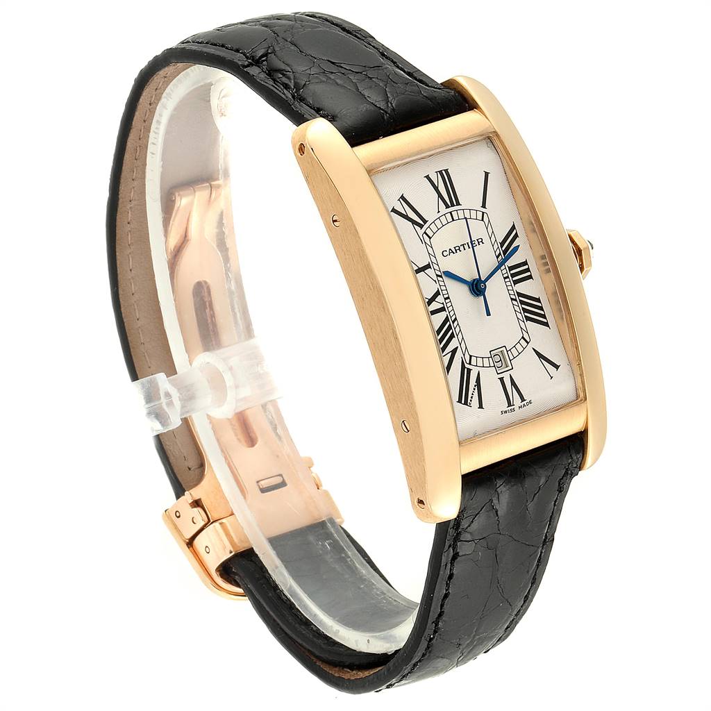 The image shows a Cartier Tank Americaine W2603156 Men's Yellow Gold Silver Dial W2603156 Men's Yellow Gold Silver Dial watch at a three-quarter angle, highlighting its rectangular face, black leather strap, and gold case.