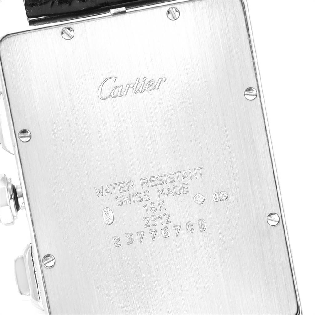 The image shows the back case of a Cartier Tank Americaine W2603358 Men's White Gold Silver Dial W2603358 Men's White Gold Silver Dial watch, featuring engravings and screws.