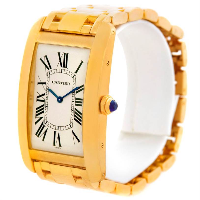 The image shows a Cartier Tank Americaine 1735 Men
s Yellow Gold Silver Dial 1735 Men
s Yellow Gold Silver Dial watch at a slight angle, highlighting its gold case, Roman numeral dial, and bracelet.