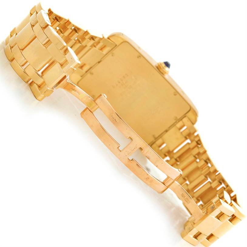 This image shows the back view of a Cartier Tank Americaine 1735 Men
s Yellow Gold Silver Dial 1735 Men
s Yellow Gold Silver Dial watch, focusing on the clasp and bracelet.