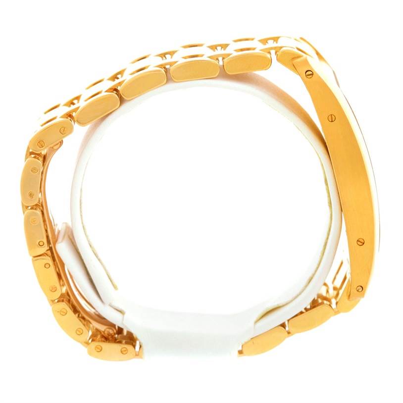 This image shows a side view of a Tank Americaine model by Cartier, highlighting its gold metal bracelet and case.