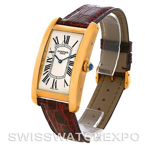 The image shows a Cartier Tank Americaine Yellow Gold Silver Dial Yellow Gold Silver Dial watch at a slight angle, displaying its rectangular face, Roman numerals, and leather strap.