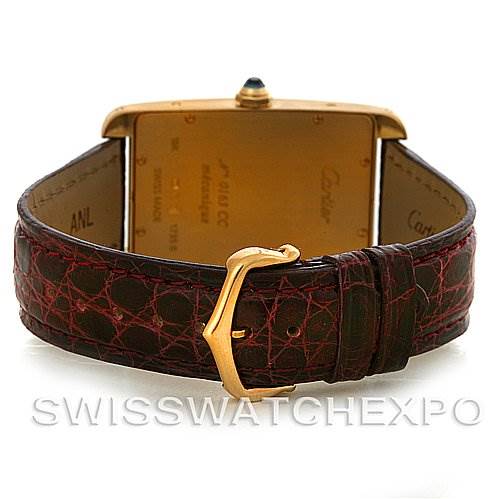 This image shows the back view of a Cartier Tank Americaine Yellow Gold Silver Dial Yellow Gold Silver Dial watch, highlighting the case back and leather strap with its buckle.