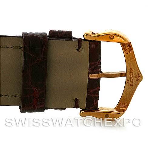 The image shows a close-up of the buckle and strap of the Cartier Tank Americaine Yellow Gold Silver Dial Yellow Gold Silver Dial watch.