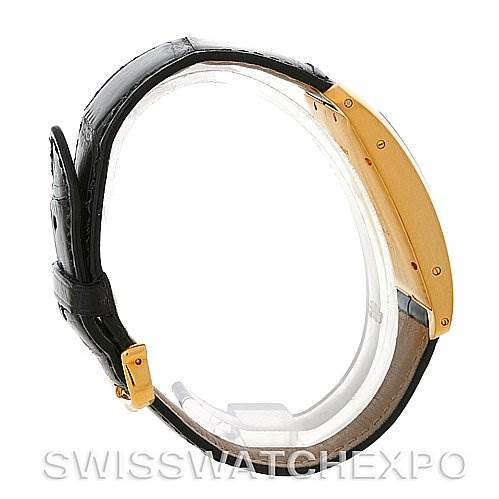 The image shows a Cartier Tank Americaine W2603156 Men
s Yellow Gold Silver Dial W2603156 Men
s Yellow Gold Silver Dial watch from a side angle, highlighting its gold case and black leather strap.