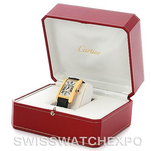 The image shows a Cartier Tank Américaine watch, presented at a slightly angled, front-facing view inside an open red box.