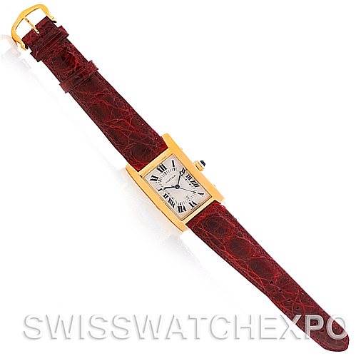 This image shows the Cartier Tank Americaine W2603556 Men's Yellow Gold Silver Dial W2603556 Men's Yellow Gold Silver Dial watch laid flat, highlighting the face, red leather strap, and gold buckle.