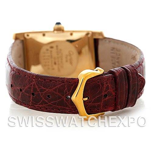 This image shows the back view of the Cartier Tank Americaine W2603556 Men's Yellow Gold Silver Dial W2603556 Men's Yellow Gold Silver Dial watch, highlighting the gold case and brown leather strap with a buckle.